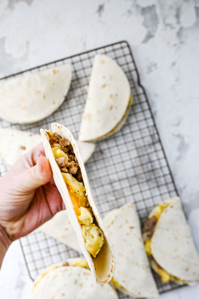 Make ahead freezer breakfast tacos are are super simple, minimal ingredient, inexpensive way to batch cook and stock up that freezer with easy hand held, already portioned breakfasts.