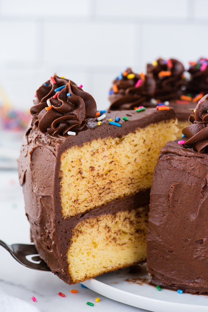 This yellow cake recipe starts with yellow cake mix but no one would know, it tastes like it’s made from scratch! Yellow birthday cake with chocolate frosting comes together fast, make a 2 or 3 layer cake with all our tips!
