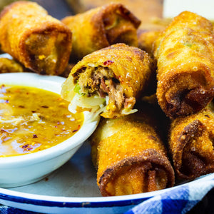 Pulled Pork Egg Rolls- these amazing southern egg rolls are full of pulled pork and coleslaw and serve with a tangy peach dipping sauce